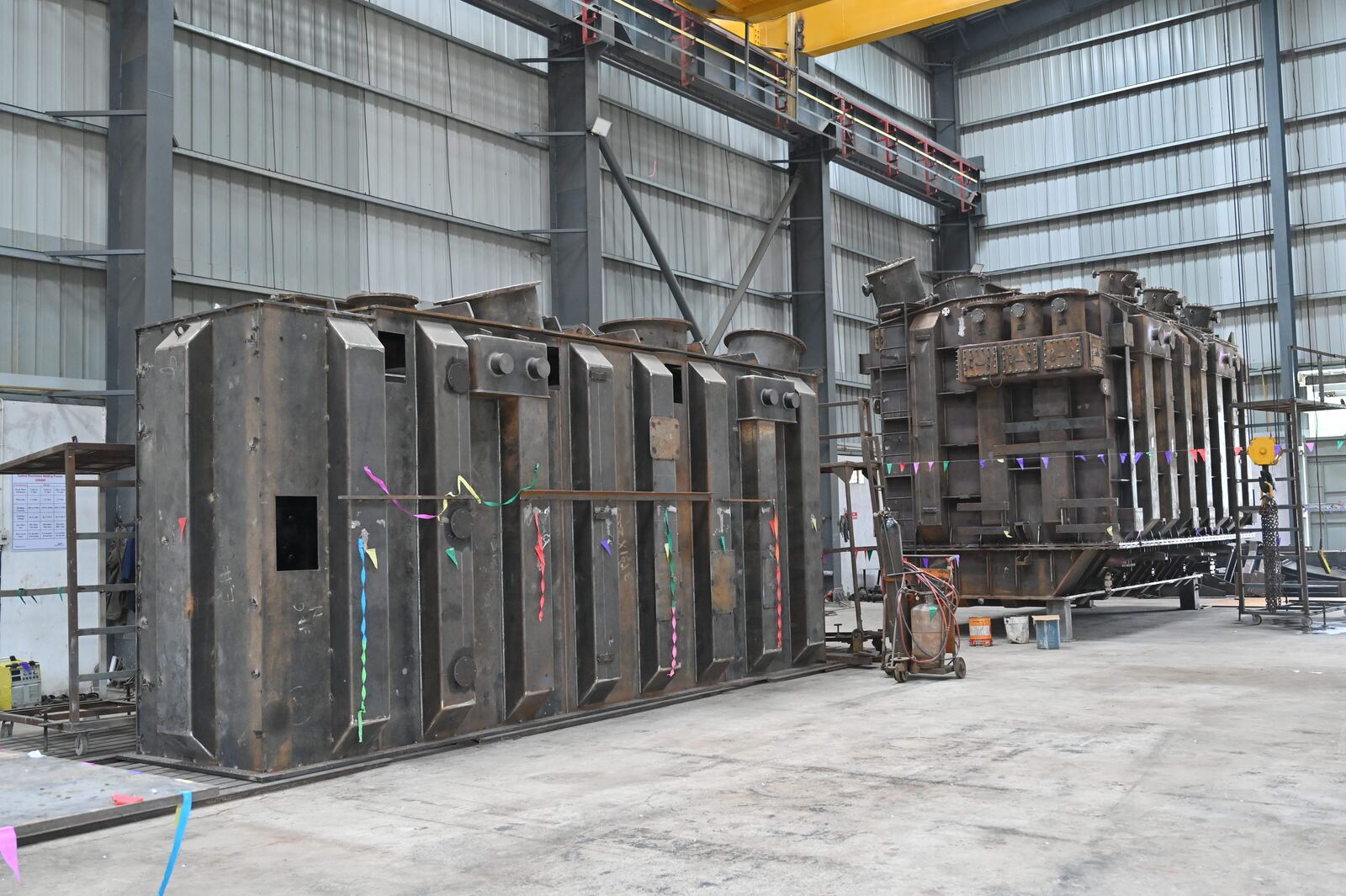 Heavy fabricated steel structures lined up in the fabrication bay