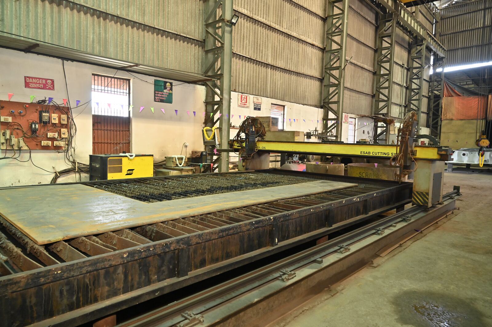 CNC profile cutting machine with gantry over a steel plate cutting bed
